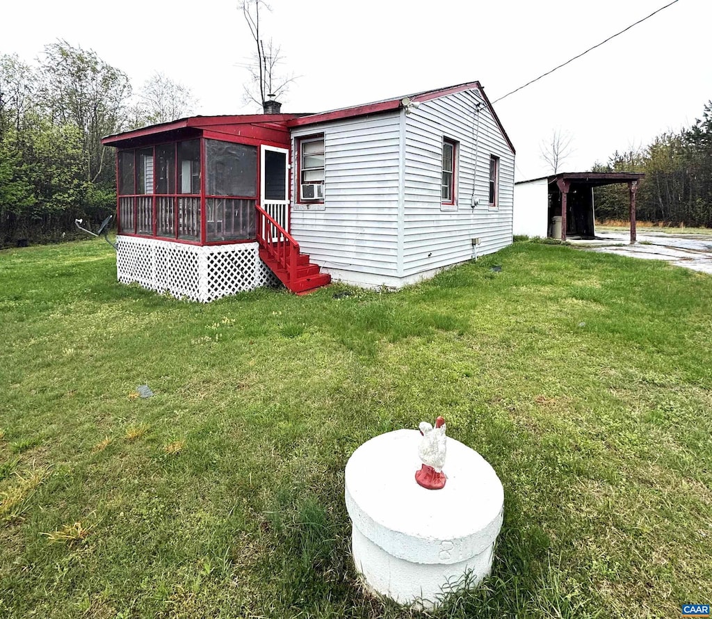 manufactured / mobile home featuring a front yard, cooling unit, and a sunroom