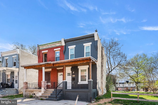 view of front of property with a porch and brick siding