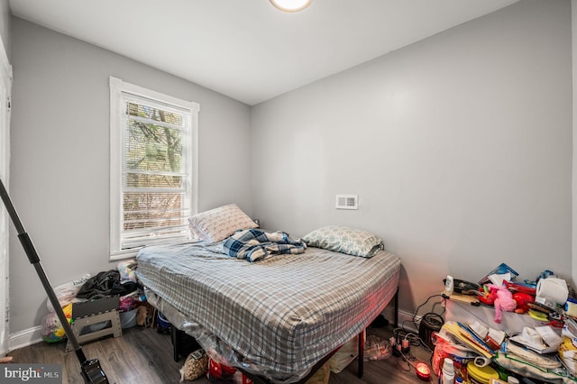 bedroom featuring baseboards and wood finished floors