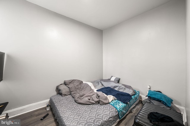 bedroom featuring baseboards and wood finished floors