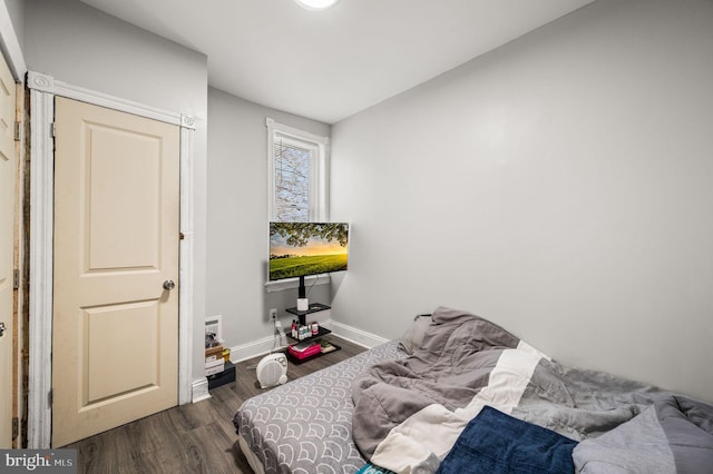 bedroom with baseboards and wood finished floors