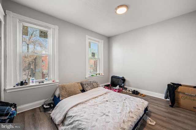 bedroom featuring baseboards and wood finished floors