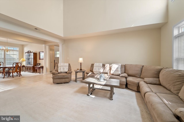 44516 Blueridge Meadows Dr, Ashburn, VA 20147 - living room with an inviting chandelier, a high ceiling, and a wealth of natural light