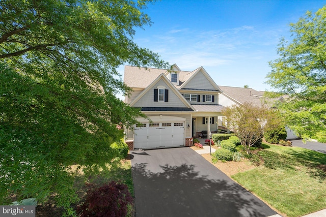 44516 Blueridge Meadows Dr, Ashburn, VA 20147 - craftsman-style house with a standing seam roof, brick siding, driveway, and a shingled roof