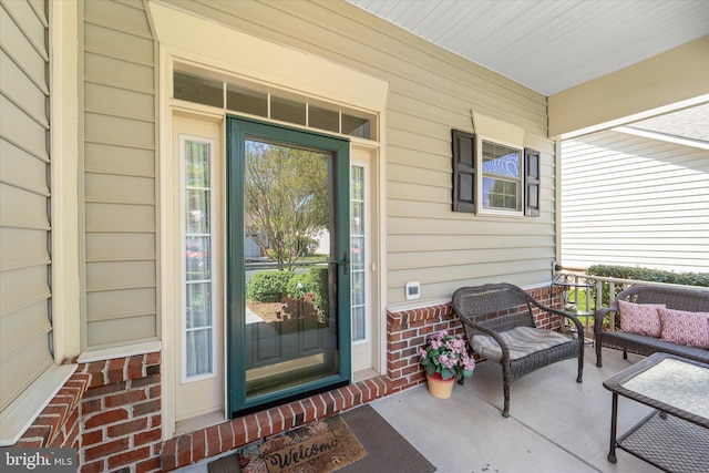 44516 Blueridge Meadows Dr, Ashburn, VA 20147 - doorway to property featuring an outdoor hangout area, a porch, and brick siding