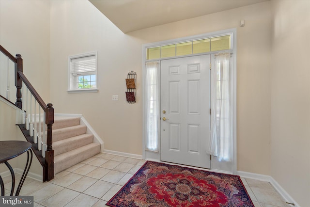 44516 Blueridge Meadows Dr, Ashburn, VA 20147 - foyer entrance featuring stairs, light tile patterned flooring, and baseboards