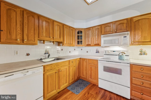 kitchen with white appliances, light countertops, backsplash, dark wood-style floors, and glass insert cabinets