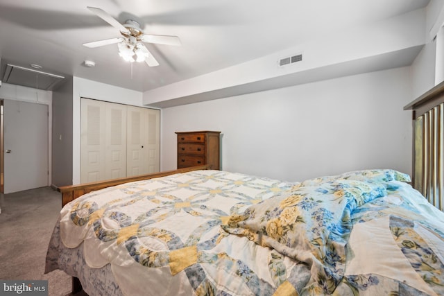bedroom with ceiling fan, carpet, attic access, visible vents, and a closet