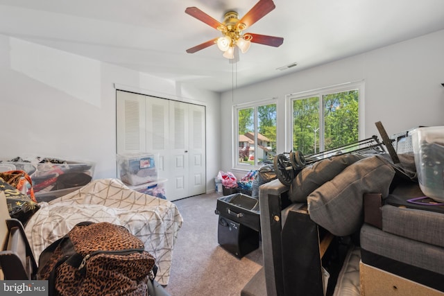 bedroom featuring carpet floors, ceiling fan, a closet, and visible vents