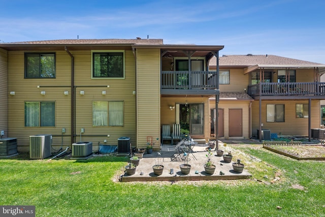 back of house featuring a patio, central AC unit, a yard, and a balcony