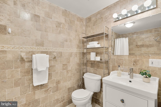 1320 Park Rd NW Unit 1, Washington, DC 20010 - bathroom with tile walls, vanity, toilet, and a shower with shower curtain