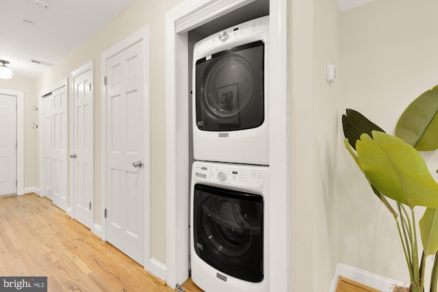 1320 Park Rd NW Unit 1, Washington, DC 20010 - laundry room with estacked washer and dryer, wood finished floors, and baseboards