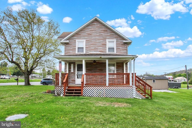view of front facade featuring a porch, stairs, and a front yard