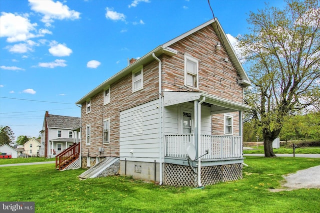 rear view of house featuring a yard and a chimney