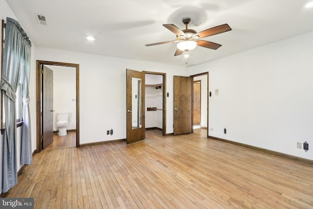 unfurnished bedroom featuring light wood-style floors, baseboards, and visible vents