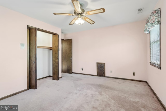 unfurnished bedroom with carpet floors, baseboards, and visible vents