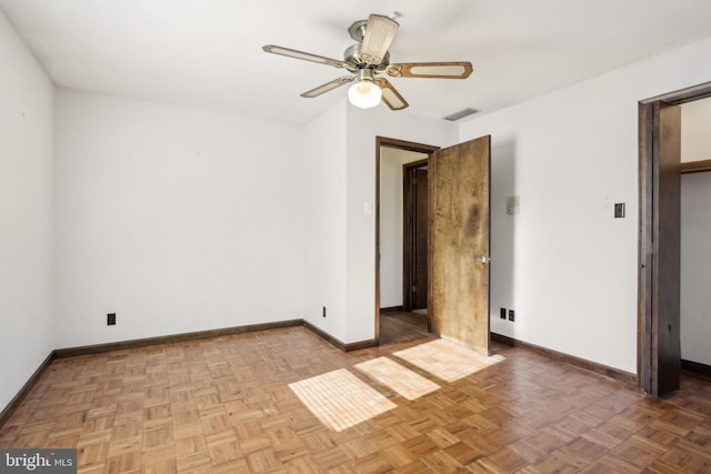 unfurnished bedroom with baseboards, ceiling fan, and visible vents