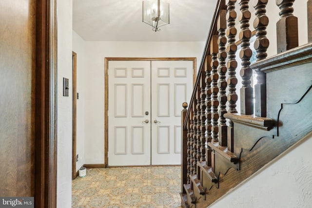 entryway featuring baseboards and tile patterned floors