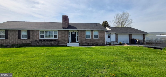 ranch-style home with a garage, a chimney, brick siding, and a front yard