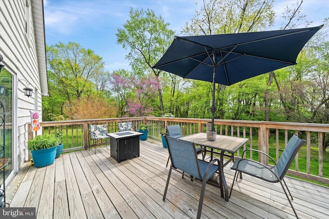 wooden deck featuring outdoor dining area