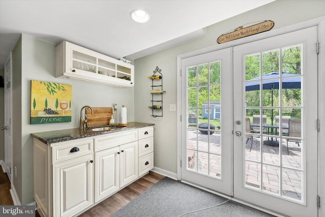 entryway with dark wood-style flooring, a sink, french doors, recessed lighting, and baseboards