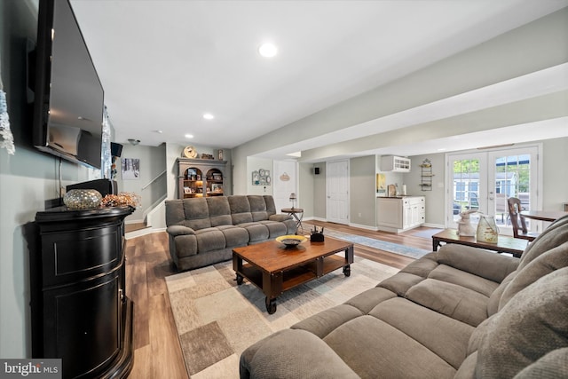 living area featuring light wood-style floors, baseboards, and recessed lighting