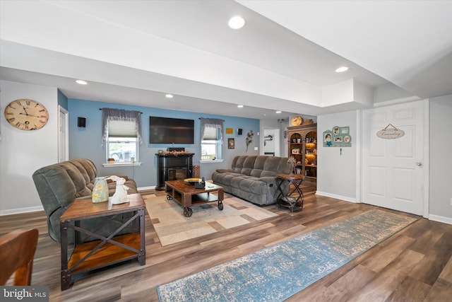 living room featuring baseboards, recessed lighting, and wood finished floors