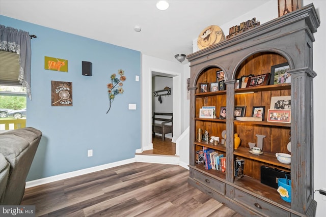 interior space with baseboards and wood finished floors