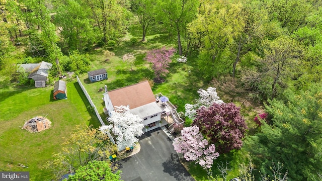 birds eye view of property with a wooded view