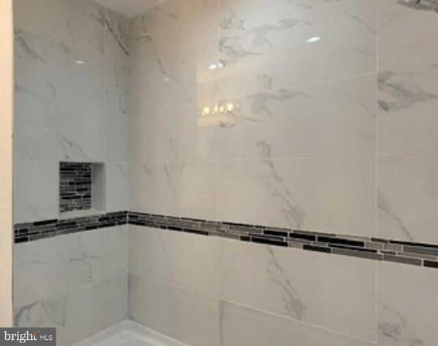 bathroom with a tile shower