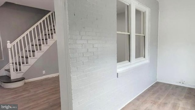 interior space featuring brick siding and stairway