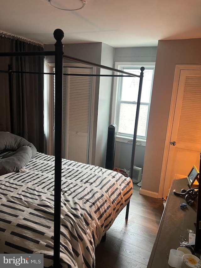 bedroom featuring baseboards and wood finished floors
