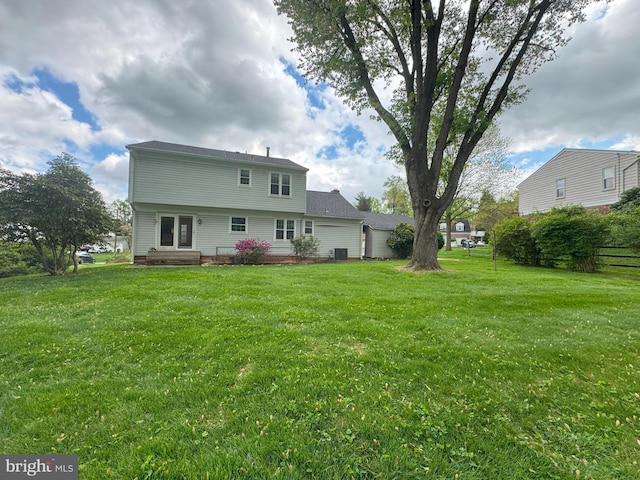 rear view of property with a lawn