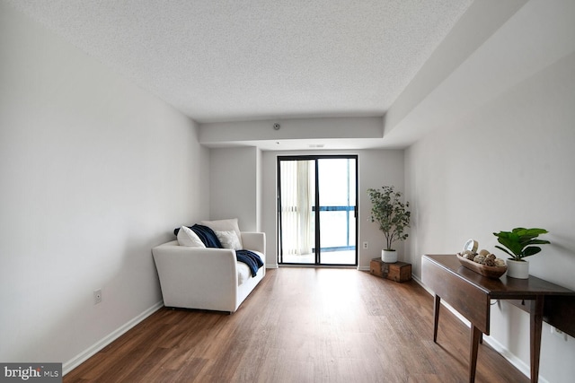 3310 N Leisure World Blvd Unit 1019, Silver Spring, MD 20906 - living area featuring wood finished floors and a textured ceiling