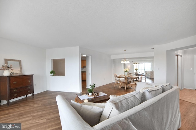 3310 N Leisure World Blvd Unit 1019, Silver Spring, MD 20906 - living room with light wood-style floors, a chandelier, and a textured ceiling