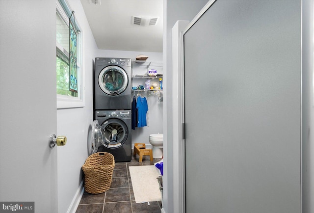 9 Sailors Way, Berlin, MD 21811 - laundry area with laundry area, baseboards, dark tile patterned floors, visible vents, and stacked washer and clothes dryer