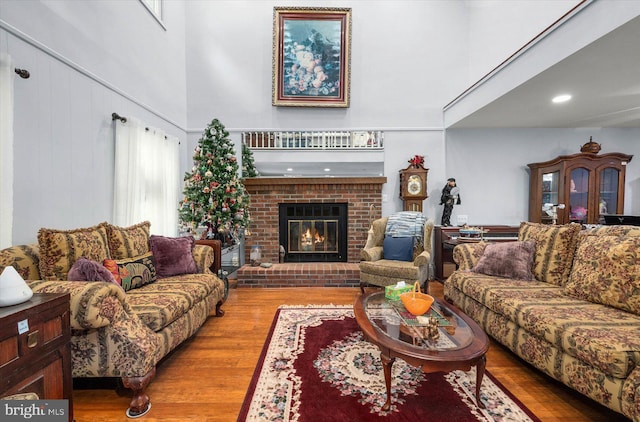 9 Sailors Way, Berlin, MD 21811 - living room with a brick fireplace, a high ceiling, and wood finished floors