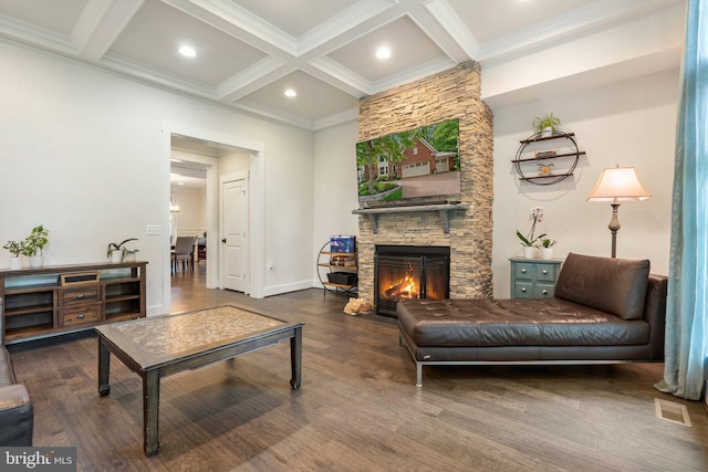 living room featuring beam ceiling, wood finished floors, coffered ceiling, a stone fireplace, and recessed lighting