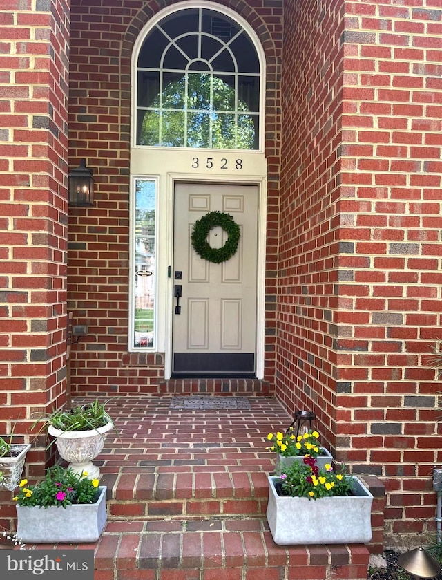 property entrance featuring brick siding