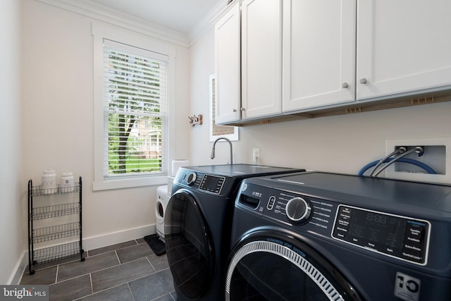washroom featuring cabinet space, washing machine and clothes dryer, baseboards, plenty of natural light, and ornamental molding