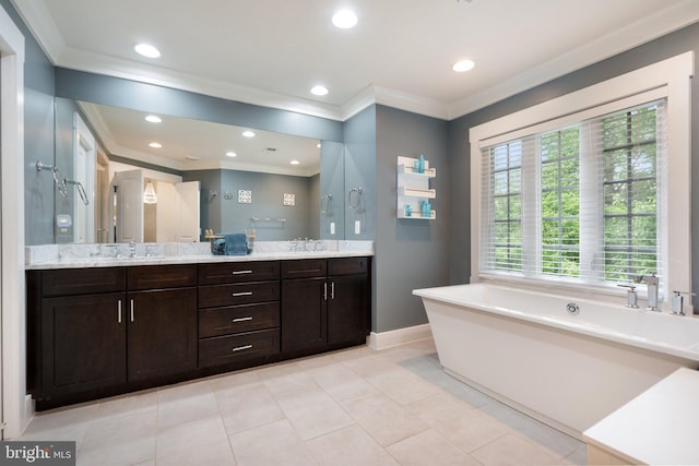 full bath with ornamental molding, baseboards, a freestanding bath, double vanity, and recessed lighting