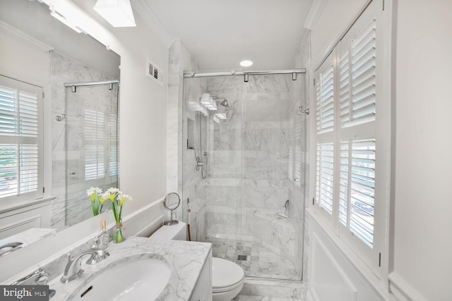 bathroom with crown molding, a stall shower, and vanity
