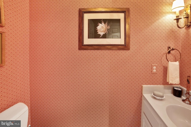 bathroom featuring vanity and toilet