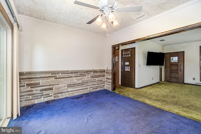carpeted empty room featuring a ceiling fan and visible vents
