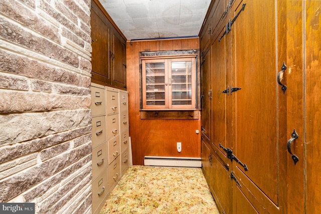 interior space with wood walls and baseboard heating
