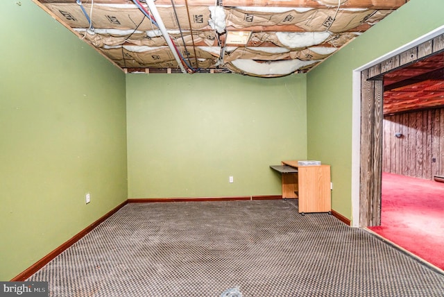 unfurnished room with carpet flooring and baseboards