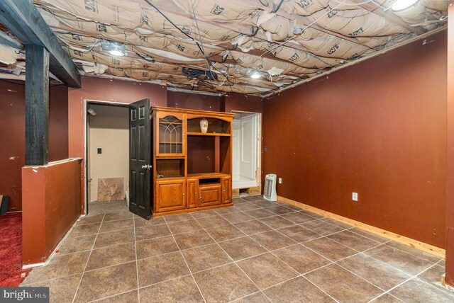 basement featuring dark tile patterned flooring
