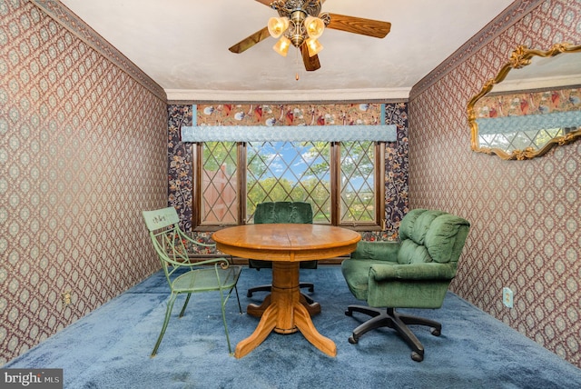 carpeted dining area featuring crown molding, a ceiling fan, and wallpapered walls