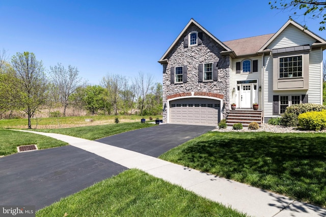 raised ranch with driveway, a front lawn, stone siding, and a garage