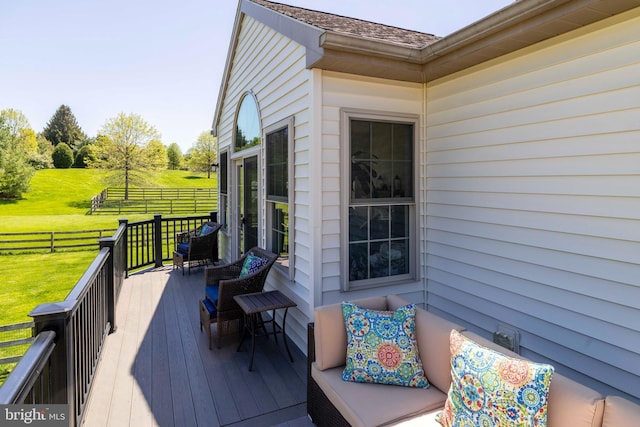 deck with a lawn and fence